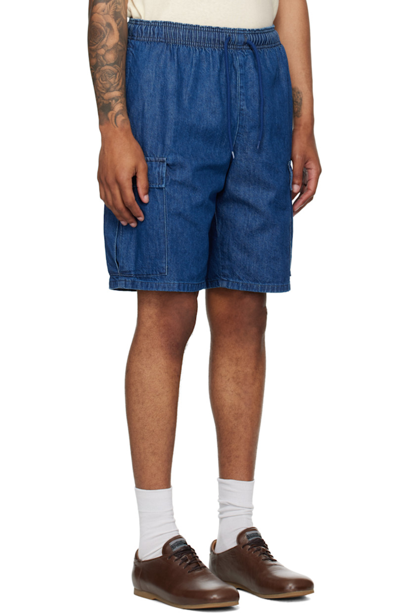 9 oz non-stretch denim shorts.

· Fading throughout
· Drawstring at elasticized waistband
· Four-pocket styling
· Cargo pocket at outseams
· Logo patch at outseam
· Logo flags at back

Supplier color: Indigo