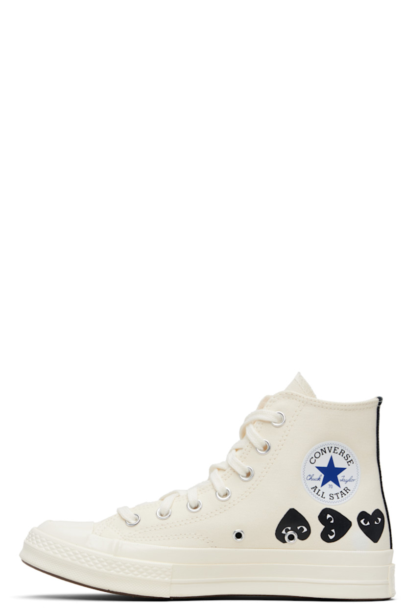 High-top canvas sneakers.

· Rubber cap toe
· Lace-up closure
· Logo printed at sides
· Eyelets and bonded logo at inner side
· Webbing trim and rubber logo patch at heel
· Cushioned Ortholite® footbed
· Treaded rubber sole

Part of the Comme des Garçons Play x Converse collaboration.

Supplier color: Beige