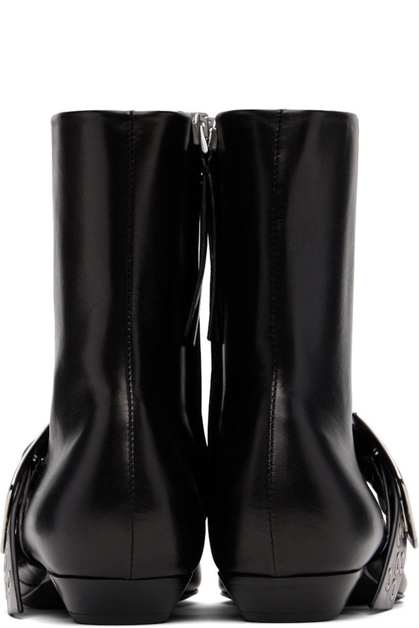 Ankle-high grained goatskin boots.

· Pointed toe 
· Pin-buckle strap with grommets at vamp
· Zip closure at inner side
· Stacked leather block heel 
· Leather sole with rubber injections 

Supplier color: Black