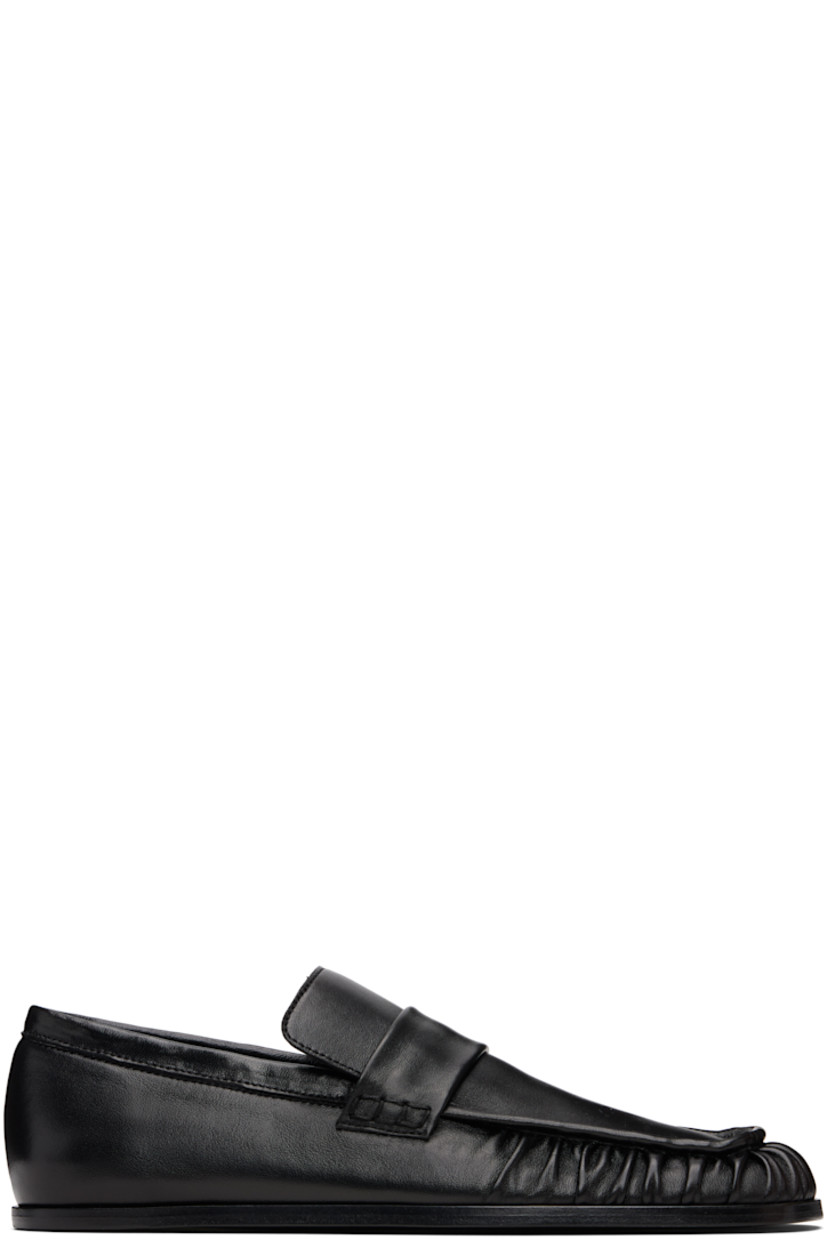 Grained sheepskin loafers.

· Square toe 
· Hand-stitched gathering at toe
· Strap at vamp
· Leather sole with rubber injections 

Supplier color: Black
