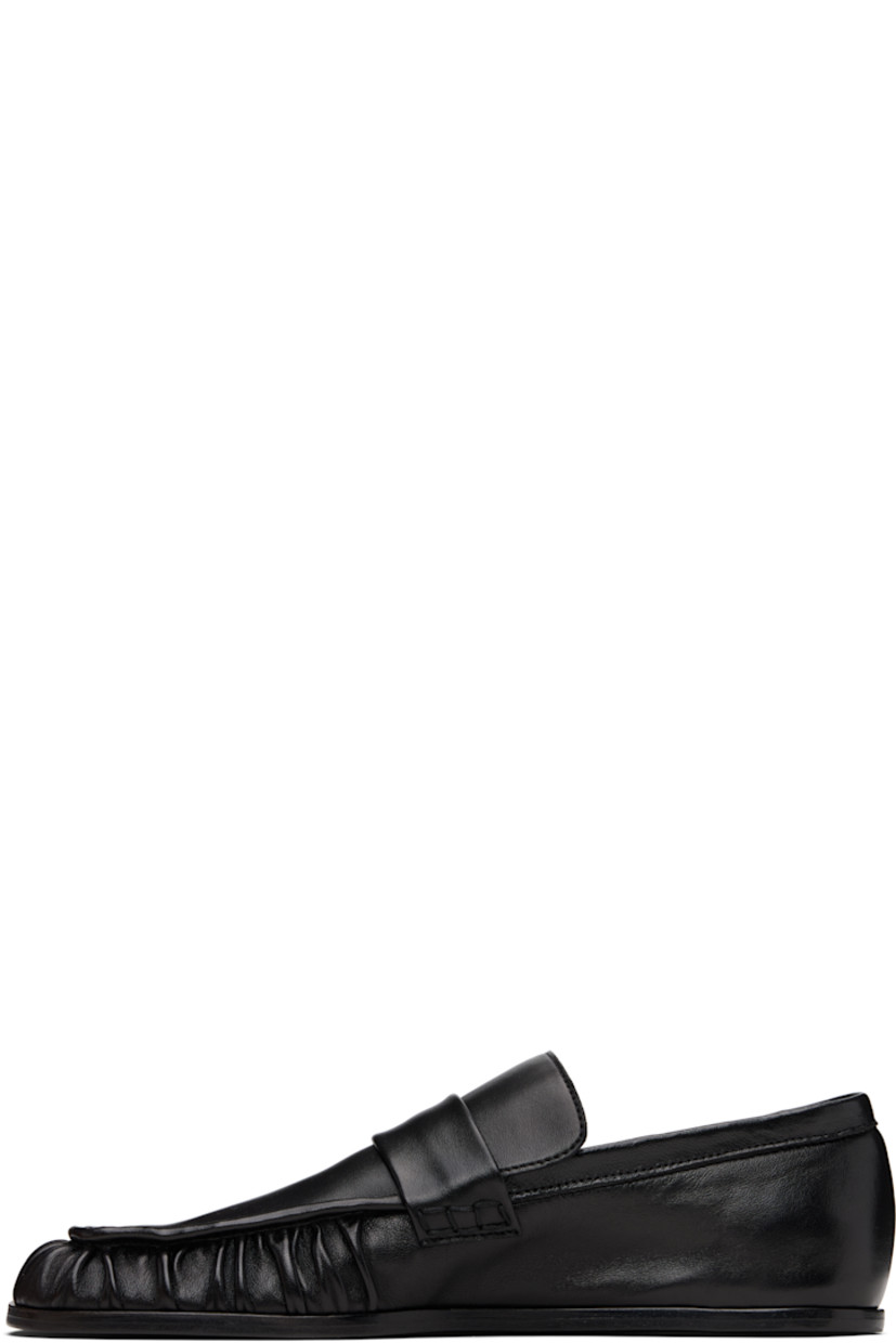 Grained sheepskin loafers.

· Square toe 
· Hand-stitched gathering at toe
· Strap at vamp
· Leather sole with rubber injections 

Supplier color: Black