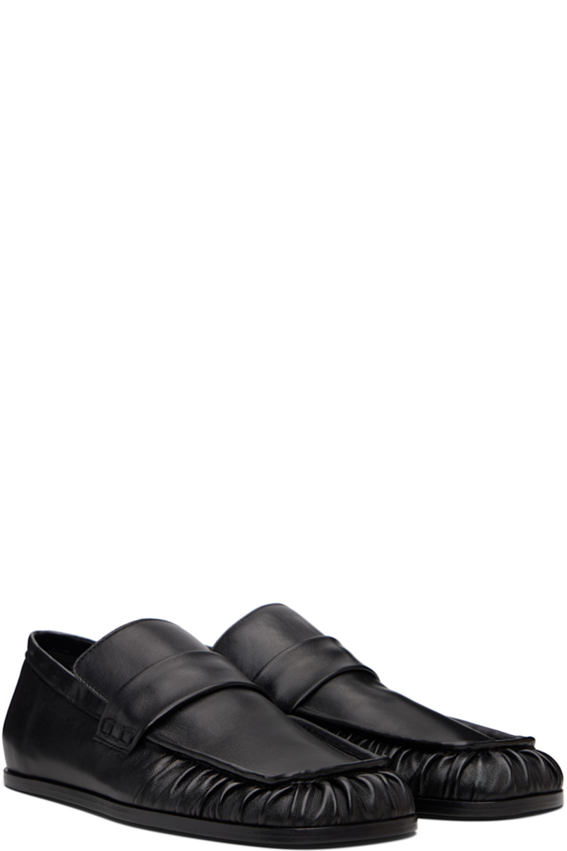 Grained sheepskin loafers.

· Square toe 
· Hand-stitched gathering at toe
· Strap at vamp
· Leather sole with rubber injections 

Supplier color: Black