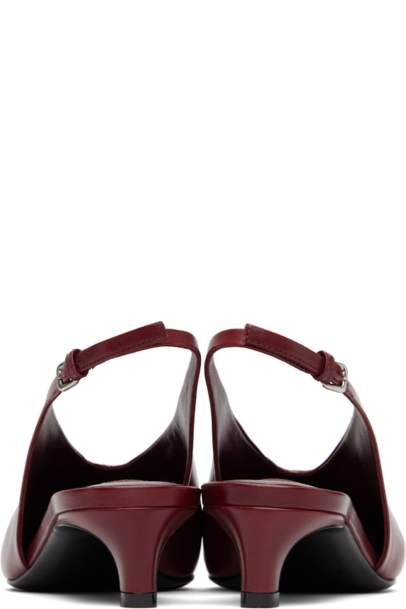 Grained calfskin heels. 

· Pointed toe 
· Stitch at vamp
· Pin-buckle slingback strap
· Covered kitten heel
· Leather sole with rubber injections
· Heel: H1.5"

Supplier color: Cedar red