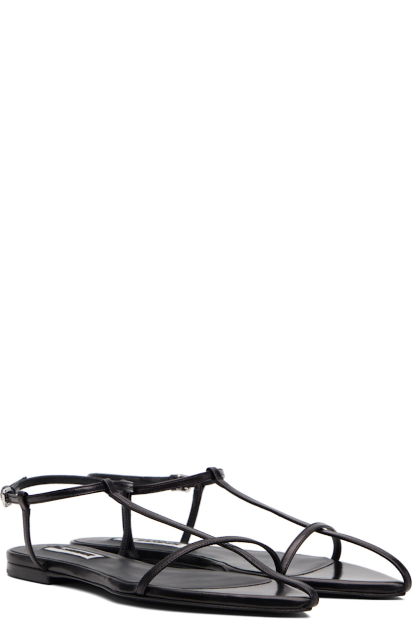 Buffed calfskin flat sandals.

· Pointed open toe 
· Pin-buckle ankle strap
· Leather sole with rubber injections

Supplier color: Black