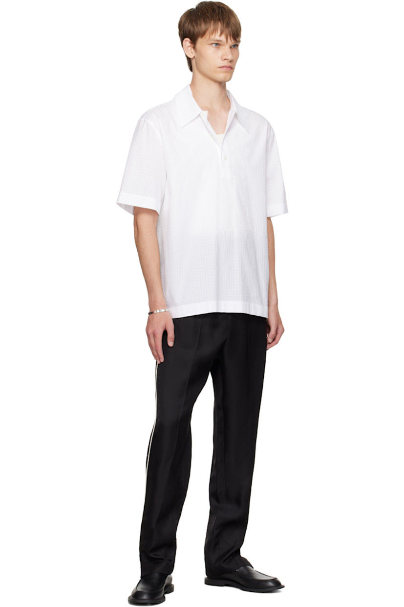 Viscose twill trousers.

· Concealed drawstring at elasticized waistband
· Four-pocket styling
· Button fly
· Pinched seams at legs
· Zip vent at cuffs
· Piping at outseams

Supplier color: Black