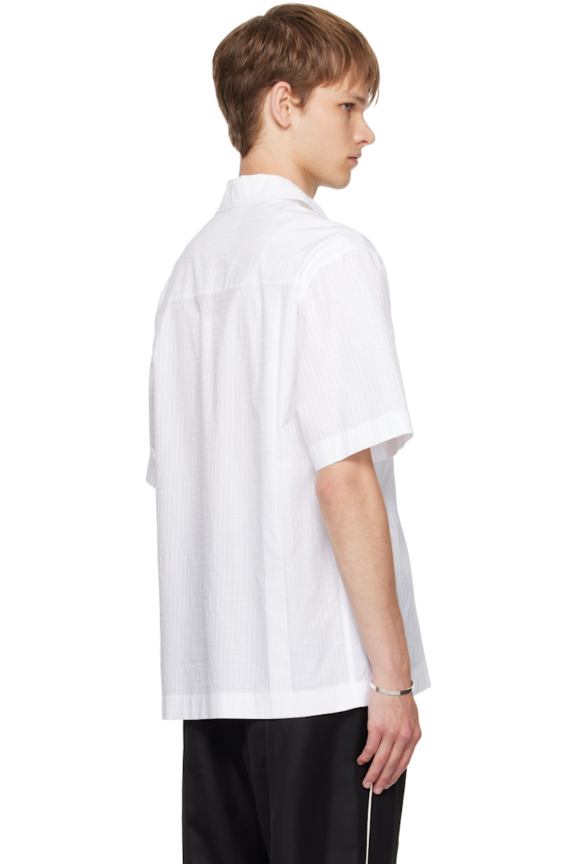 Cotton ripstop polo.

· Spread collar
· Three-button placket
· Pleats at back yoke

Supplier color: Optic white