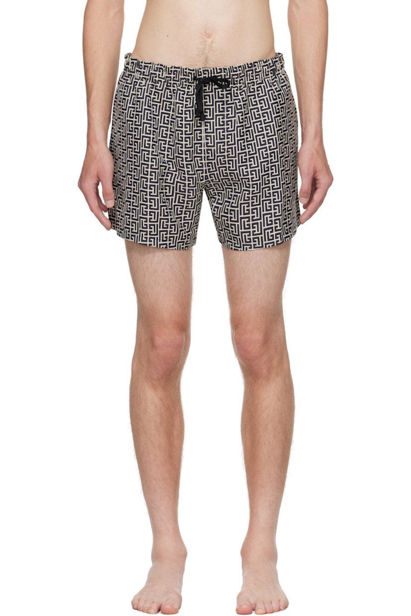 Stretch nylon twill swim shorts.

· Jacquard logo graphic pattern throughout 
· Drawstring at elasticized waistband 
· Three-pocket styling
· Grommets at back waist
· Mesh brief-style lining 

Supplier color: Ivory/Black
