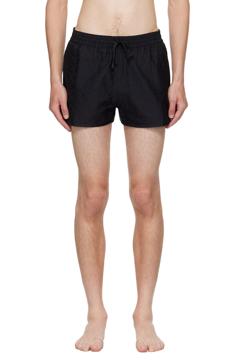 Twill swim shorts.

· Jacquard logo graphic pattern throughout 
· Drawstring at elasticized waistband 
· Three-pocket styling
· Grommets at back waist
· Mesh brief-style lining 

Supplier color: Black