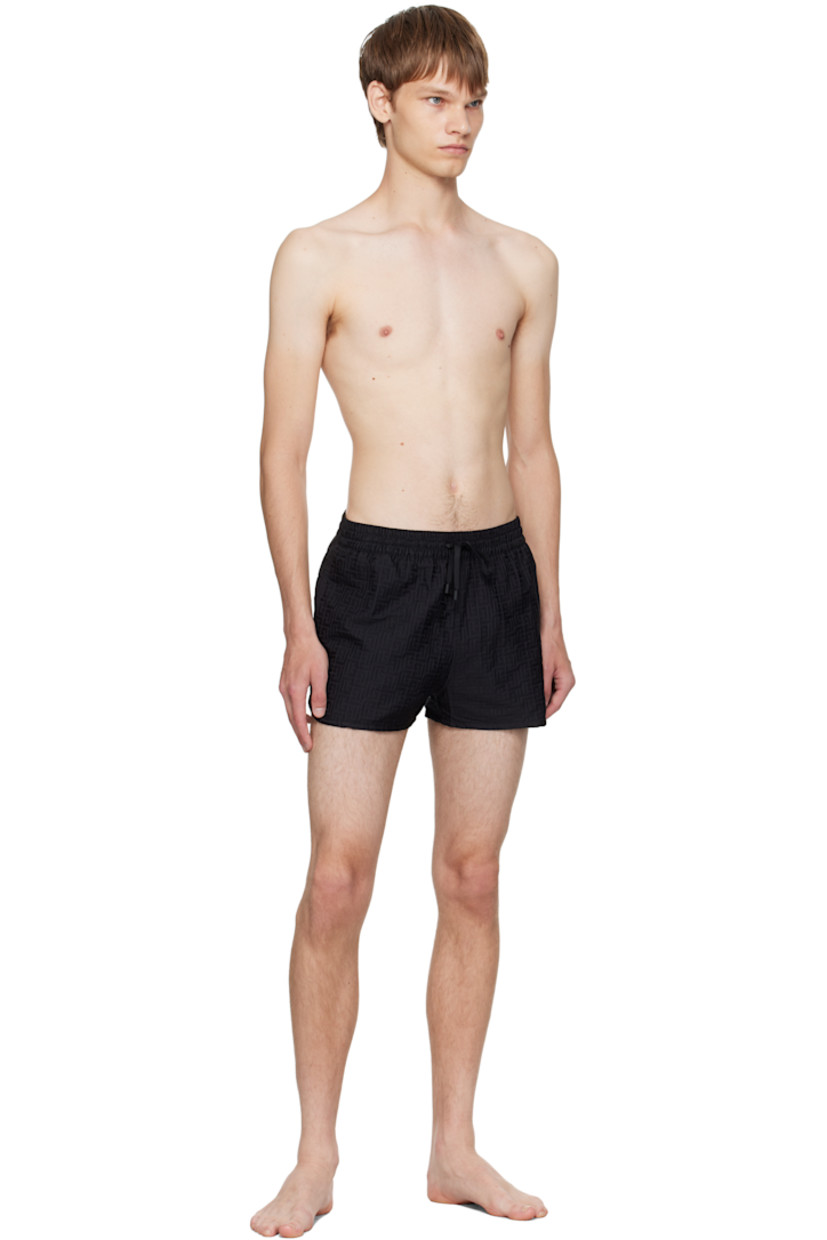 Twill swim shorts.

· Jacquard logo graphic pattern throughout 
· Drawstring at elasticized waistband 
· Three-pocket styling
· Grommets at back waist
· Mesh brief-style lining 

Supplier color: Black