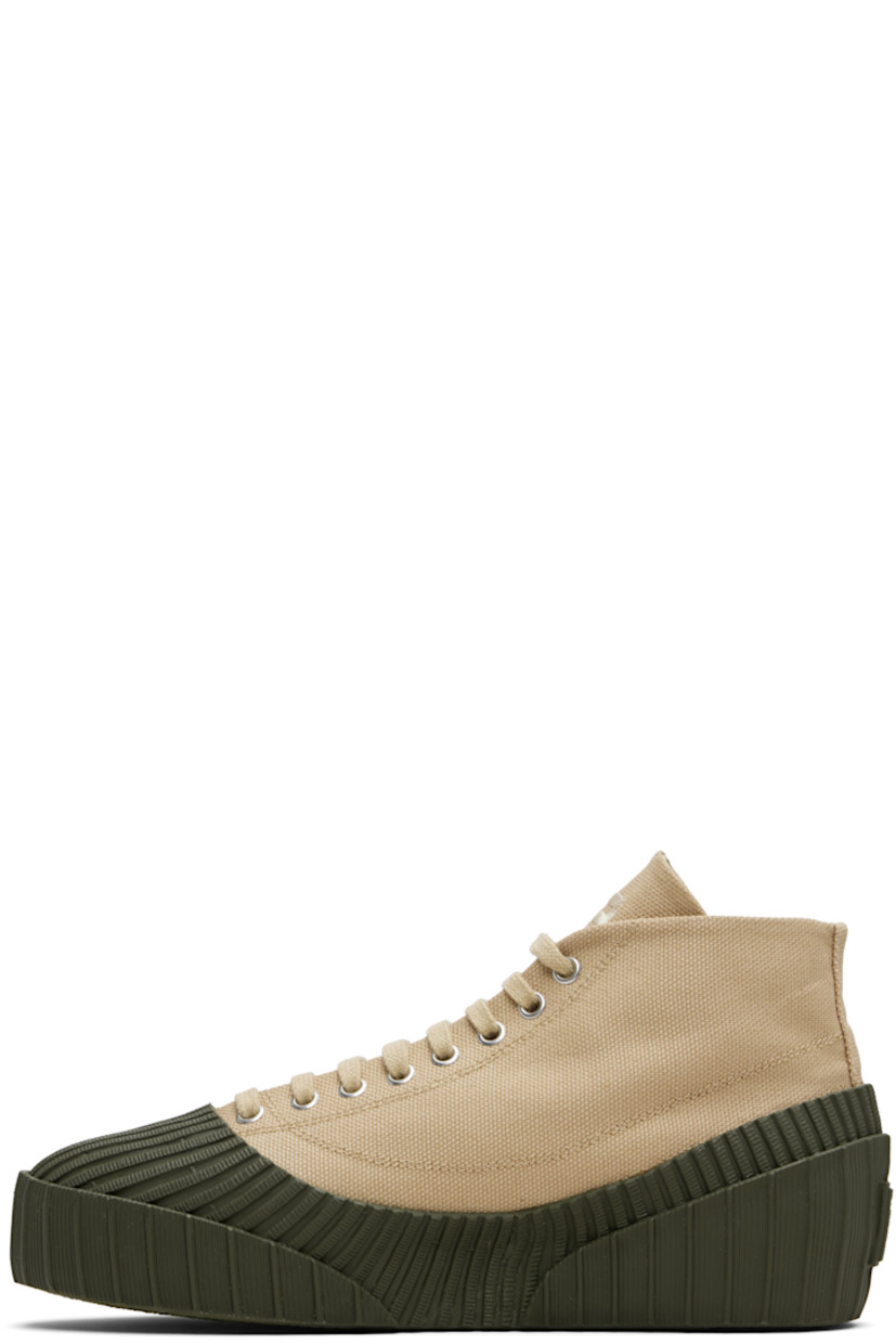 High-top cotton canvas and rubber sneakers.

· Rubber cap toe
· Lace-up closure
· Logo embroidered at tongue
· Rubberized logo patch at outer side and heel
· Canvas lining
· Treaded vulcanized rubber sole

Supplier color: Beige