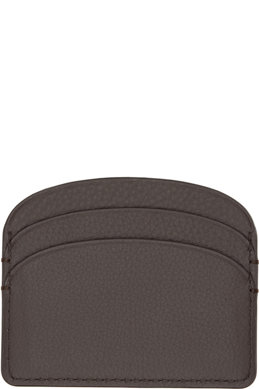 Pebble-grained leather card holder. 

· Gold-tone logo stamp at face
· Four card slots 
· Central note slot 
· Twill lining
· H3.25" x W4"

Supplier color: Tonka