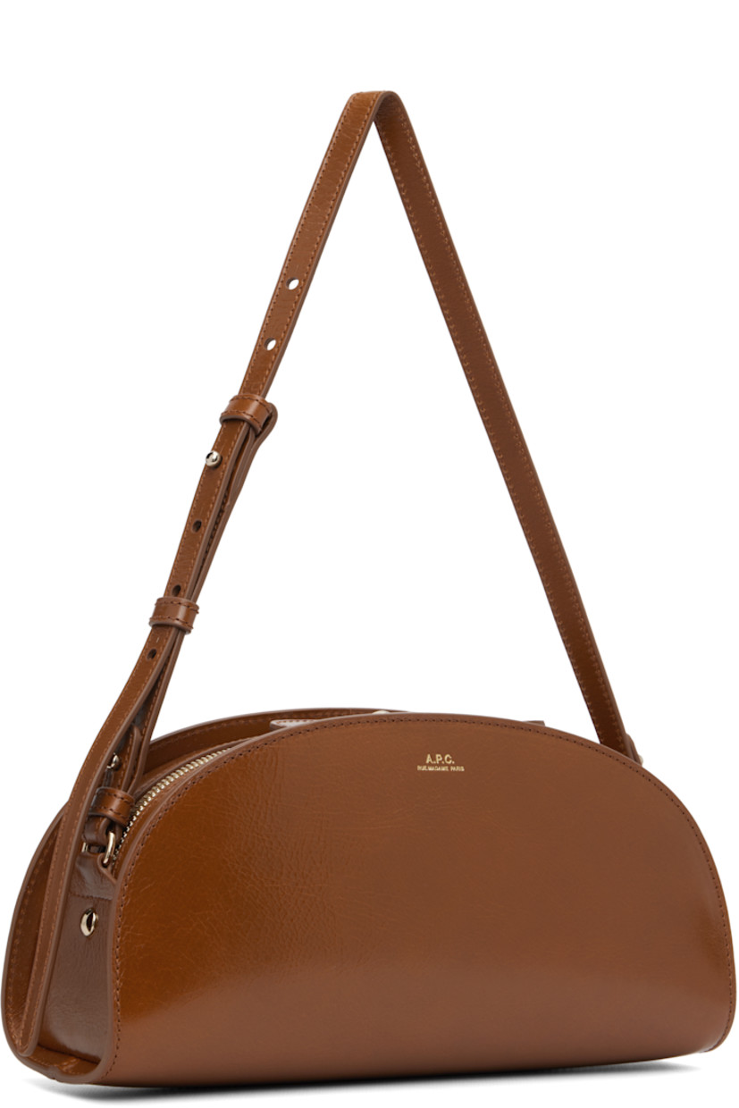 Crackled patent calfskin shoulder bag.

· Adjustable and detachable shoulder strap
· Gold-tone logo stamp at face
· Two-way zip closure
· Patch pocket at interior
· Cotton twill lining
· Gold-tone hardware
· H5.5" x W10.5" x D3.5"

Supplier color: Coffee
