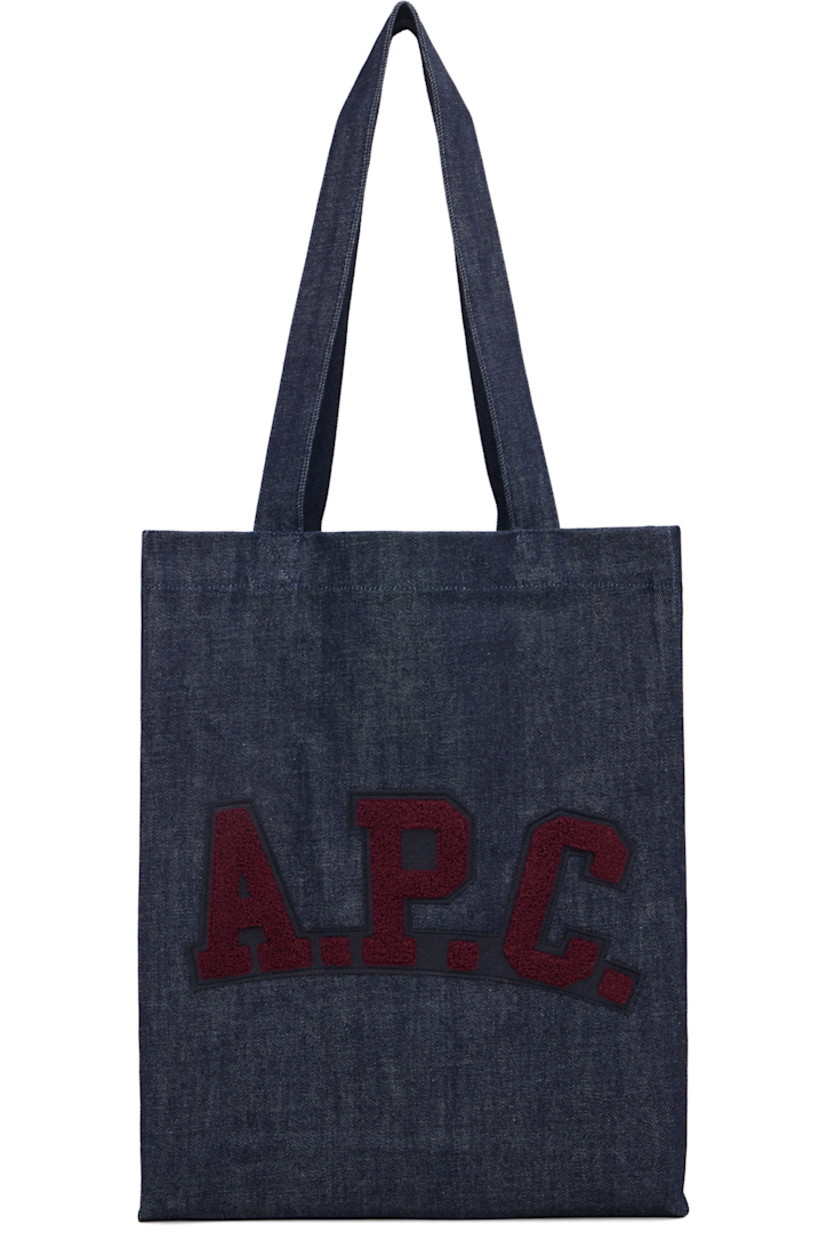 Denim tote.

· Twin shoulder straps
· Felted and bouclé logo patch at face
· Open throat
· Patch pocket at interior 
· Unlined
· H15" x W12" x D3.5"

Supplier color: Indigo