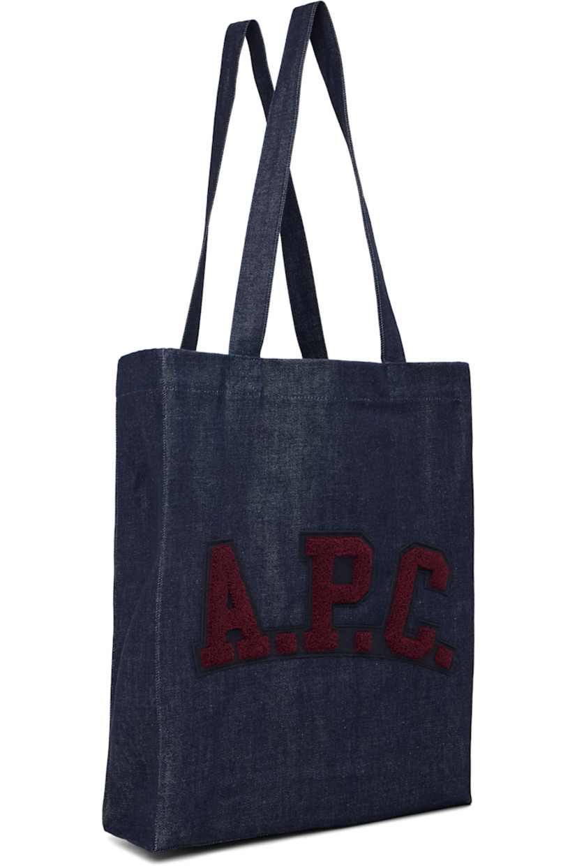 Denim tote.

· Twin shoulder straps
· Felted and bouclé logo patch at face
· Open throat
· Patch pocket at interior 
· Unlined
· H15" x W12" x D3.5"

Supplier color: Indigo