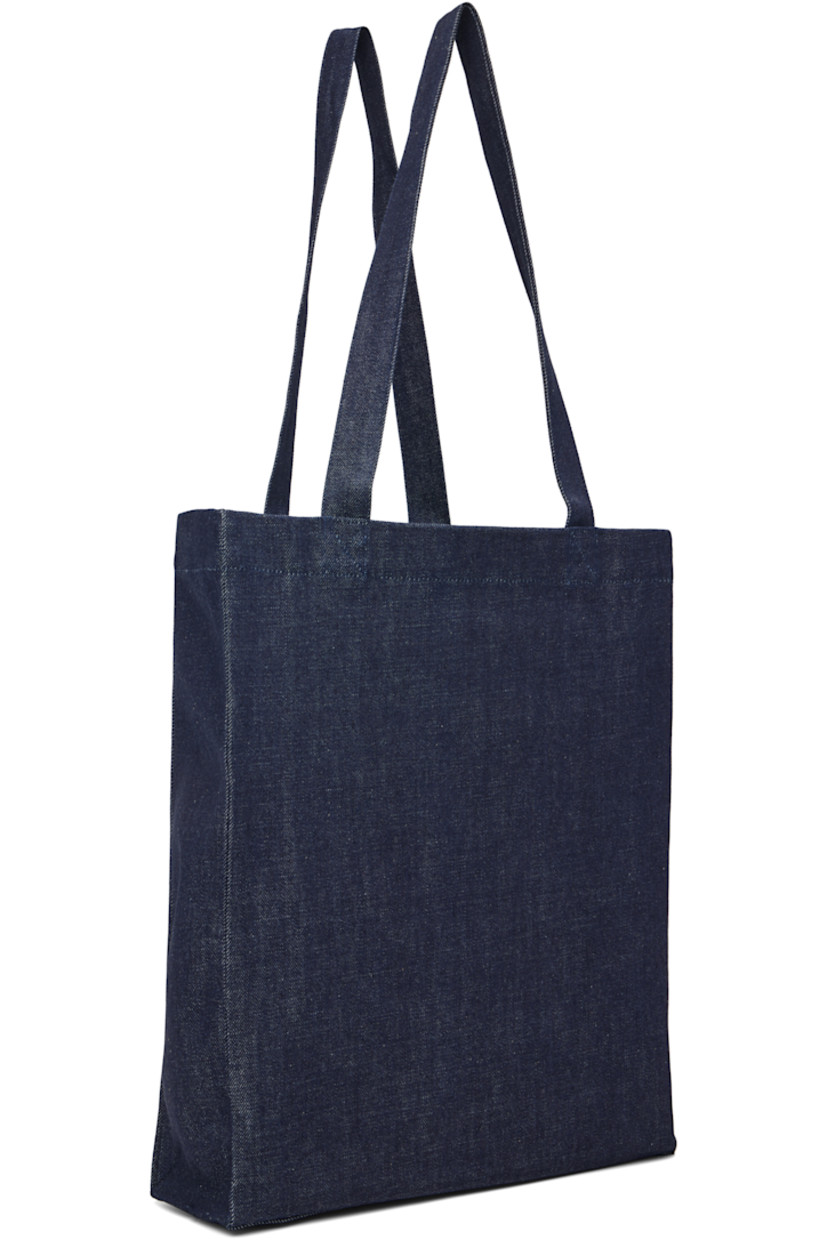 Denim tote.

· Twin shoulder straps
· Felted and bouclé logo patch at face
· Open throat
· Patch pocket at interior 
· Unlined
· H15" x W12" x D3.5"

Supplier color: Indigo