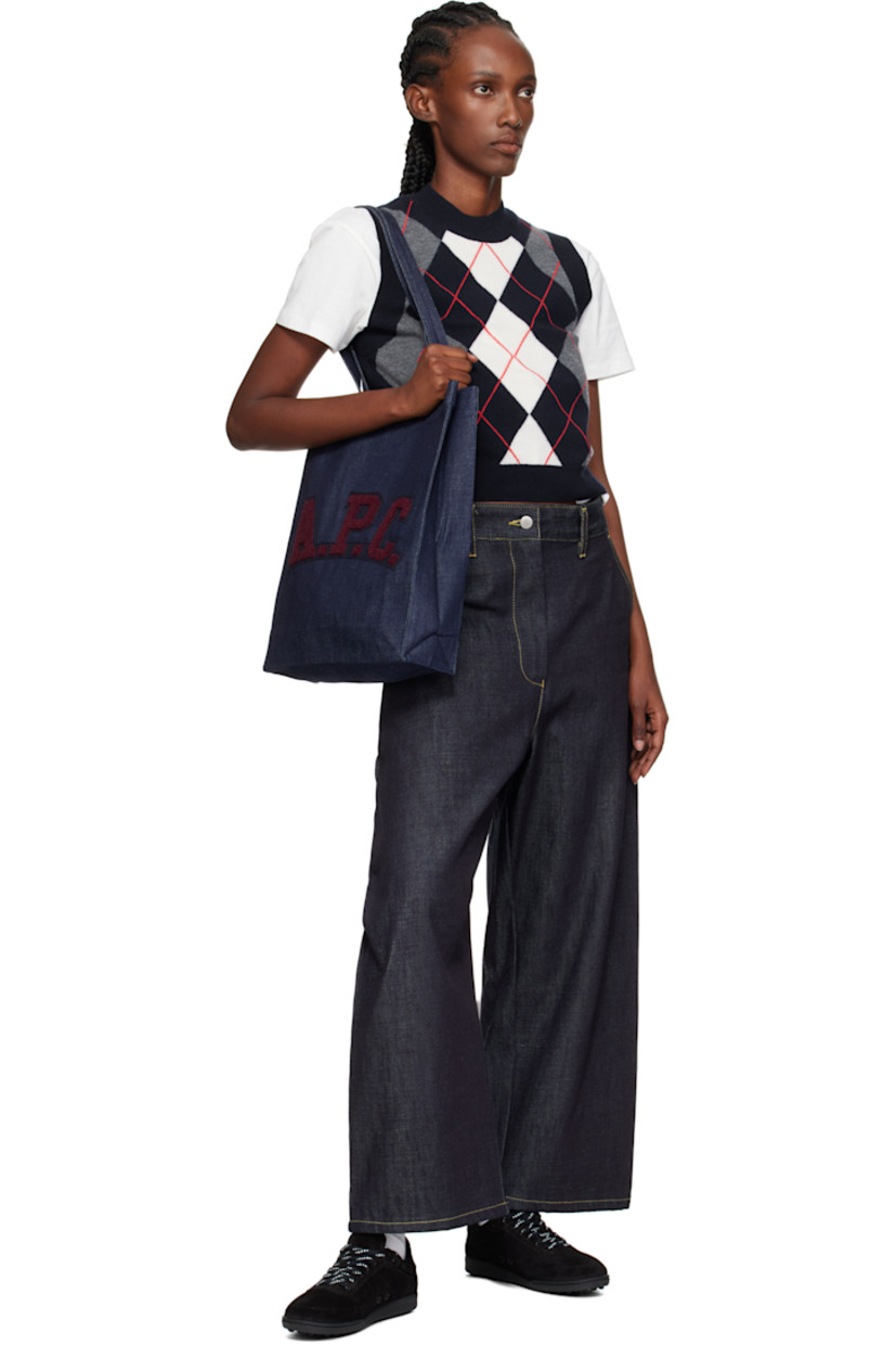 Denim tote.

· Twin shoulder straps
· Felted and bouclé logo patch at face
· Open throat
· Patch pocket at interior 
· Unlined
· H15" x W12" x D3.5"

Supplier color: Indigo