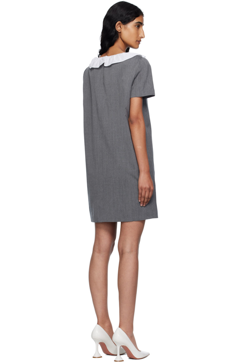 Wool canvas minidress.

· Ruffled trim at scoop neck
· Button closure
· Welt pocket and darts at chest
· Seam pockets
· Full satin lining

Supplier color: Grey