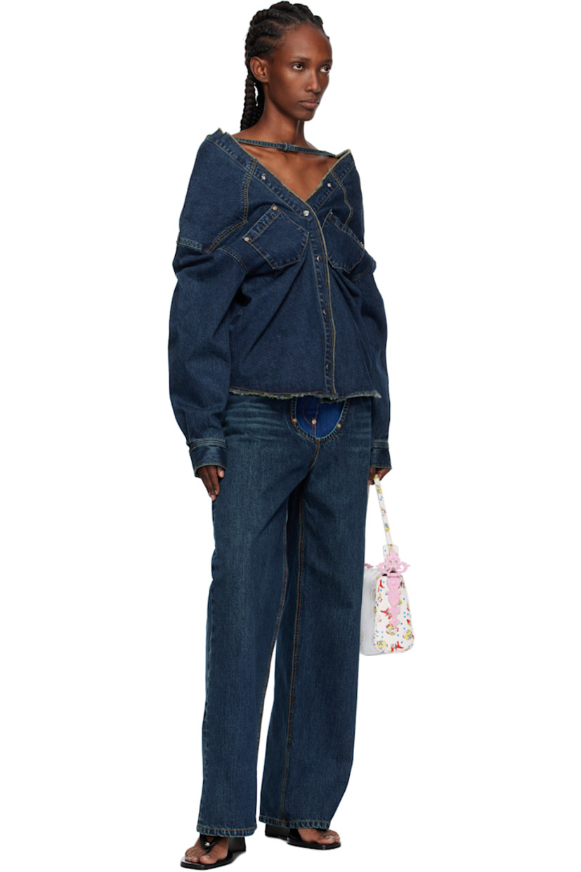 Non-stretch denim top.

· Fading throughout
· Strap with bow at boatneck
· Frayed edge at collar and hem
· Press-stud closure
· Patch pockets at chest
· Press-stud barrel cuffs
· Contrast stitching in tan

Supplier color: Dbl