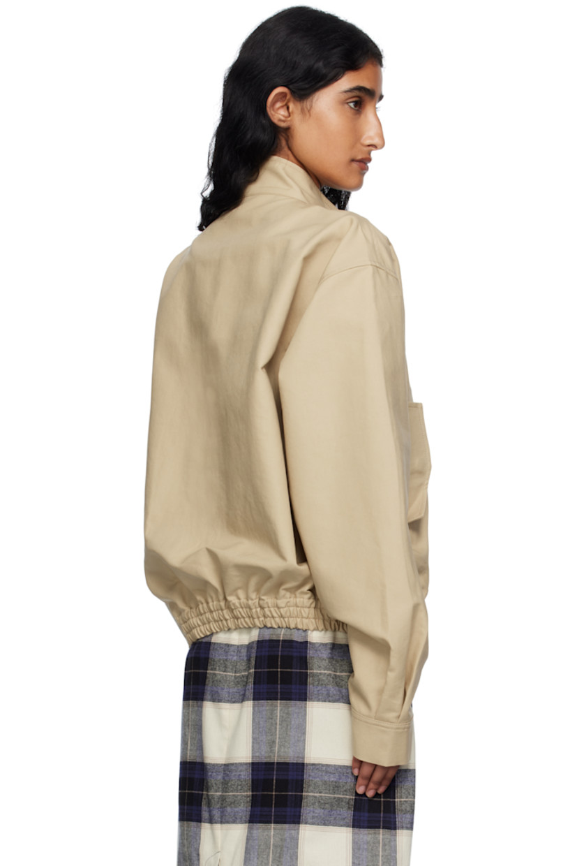 Cotton broadcloth jacket.

· Press-stud fastening at stand collar
· Zip closure
· Text embroidered at front
· Flap pockets
· Elasticized hem
· Buttoned barrel cuffs

Supplier color: Bg