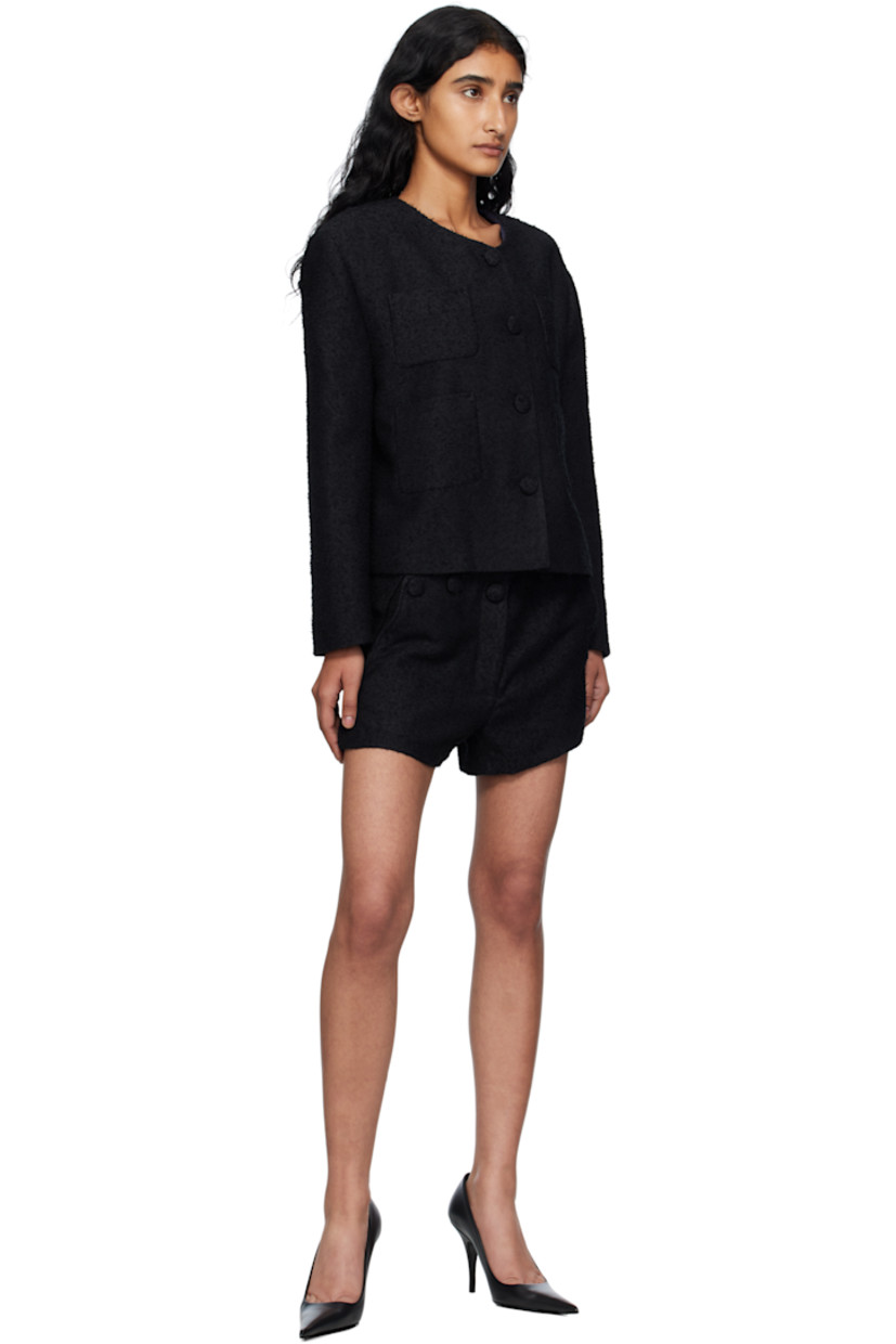 Bouclé tweed jacket.

· Round neck
· Button closure
· Patch pockets at front
· Padded shoulders
· Full satin lining

Supplier color: Bk