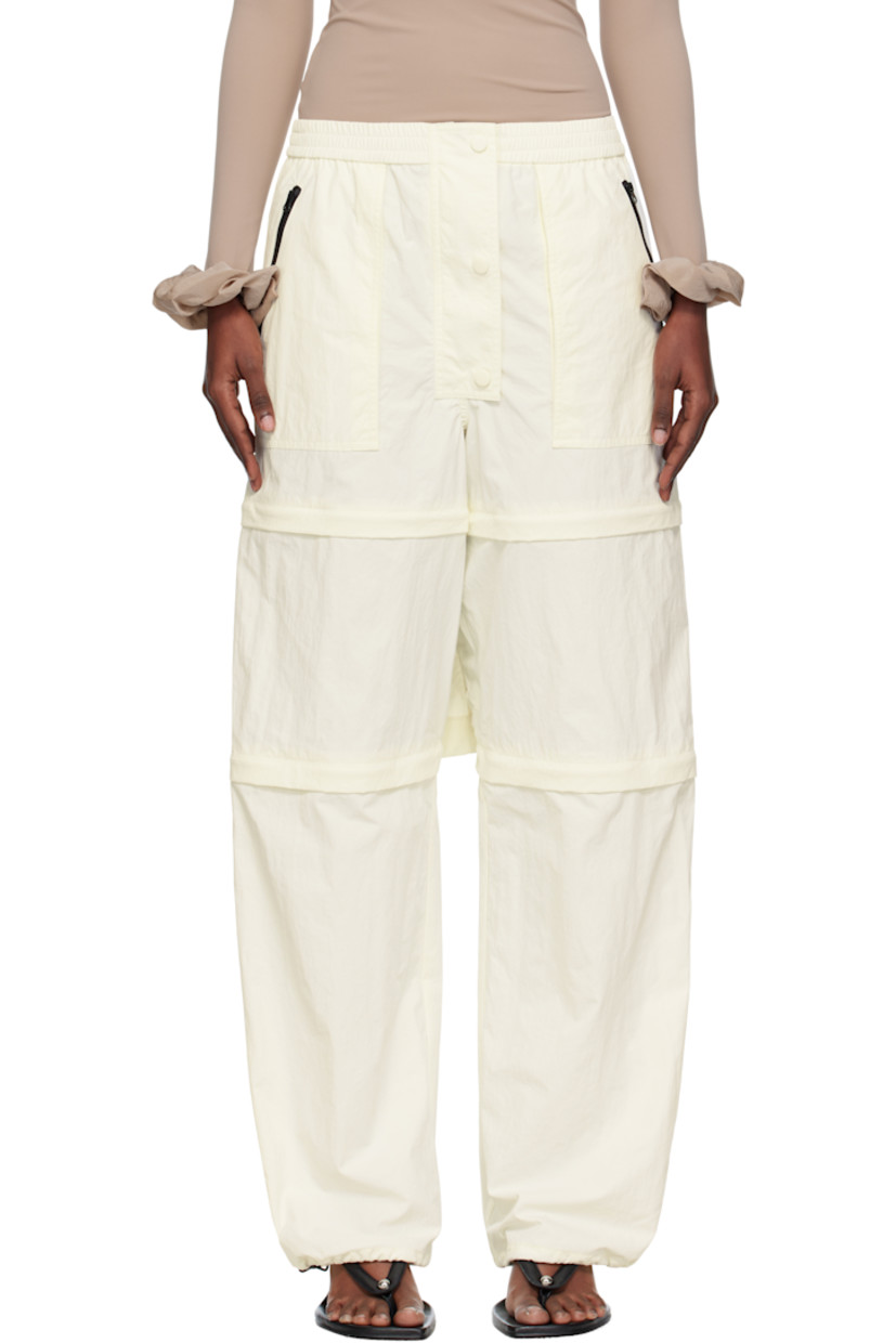 Nylon taffeta trousers.

· Elasticized waistband
· Three-pocket styling
· Zip fly
· Text and logo printed at front leg
· Detachable zip panels at legs for shorts styling
· Bungee-style drawstring at cuffs

Supplier color: Iv