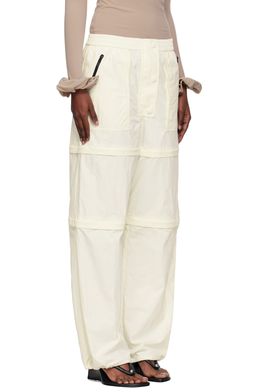 Nylon taffeta trousers.

· Elasticized waistband
· Three-pocket styling
· Zip fly
· Text and logo printed at front leg
· Detachable zip panels at legs for shorts styling
· Bungee-style drawstring at cuffs

Supplier color: Iv