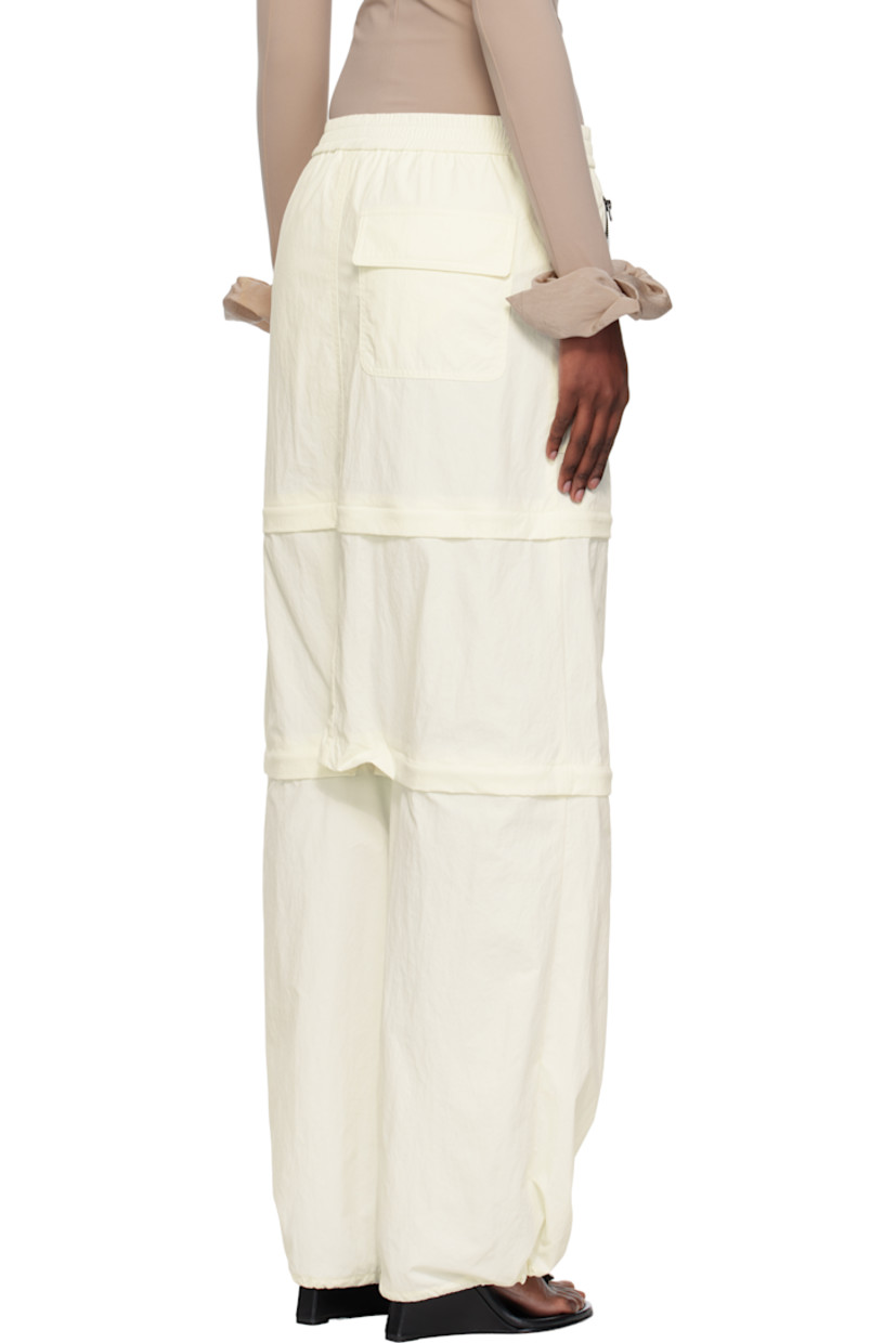 Nylon taffeta trousers.

· Elasticized waistband
· Three-pocket styling
· Zip fly
· Text and logo printed at front leg
· Detachable zip panels at legs for shorts styling
· Bungee-style drawstring at cuffs

Supplier color: Iv
