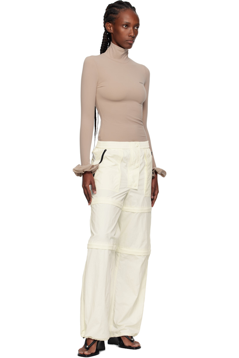 Nylon taffeta trousers.

· Elasticized waistband
· Three-pocket styling
· Zip fly
· Text and logo printed at front leg
· Detachable zip panels at legs for shorts styling
· Bungee-style drawstring at cuffs

Supplier color: Iv