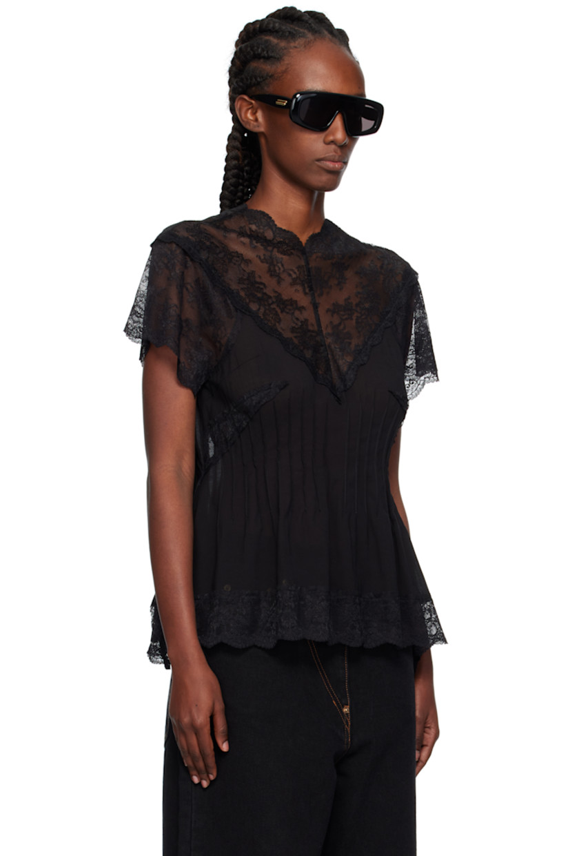 Semi-sheer modal-blend lace and chiffon top.

· Darts throughout
· Scalloped edge at V-neck, hem, and cuffs
· Button and zip closure at back

Supplier color: Bk