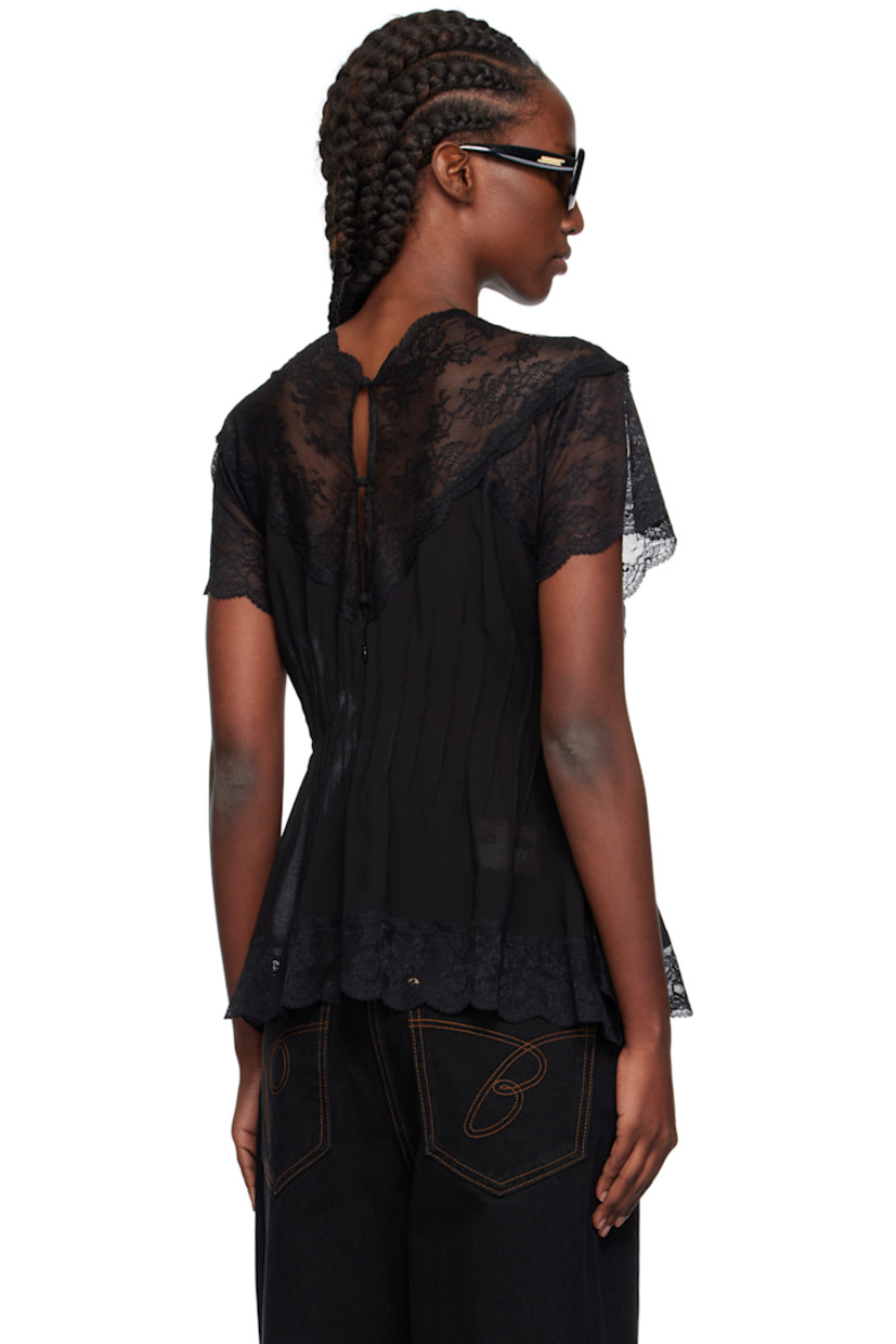 Semi-sheer modal-blend lace and chiffon top.

· Darts throughout
· Scalloped edge at V-neck, hem, and cuffs
· Button and zip closure at back

Supplier color: Bk