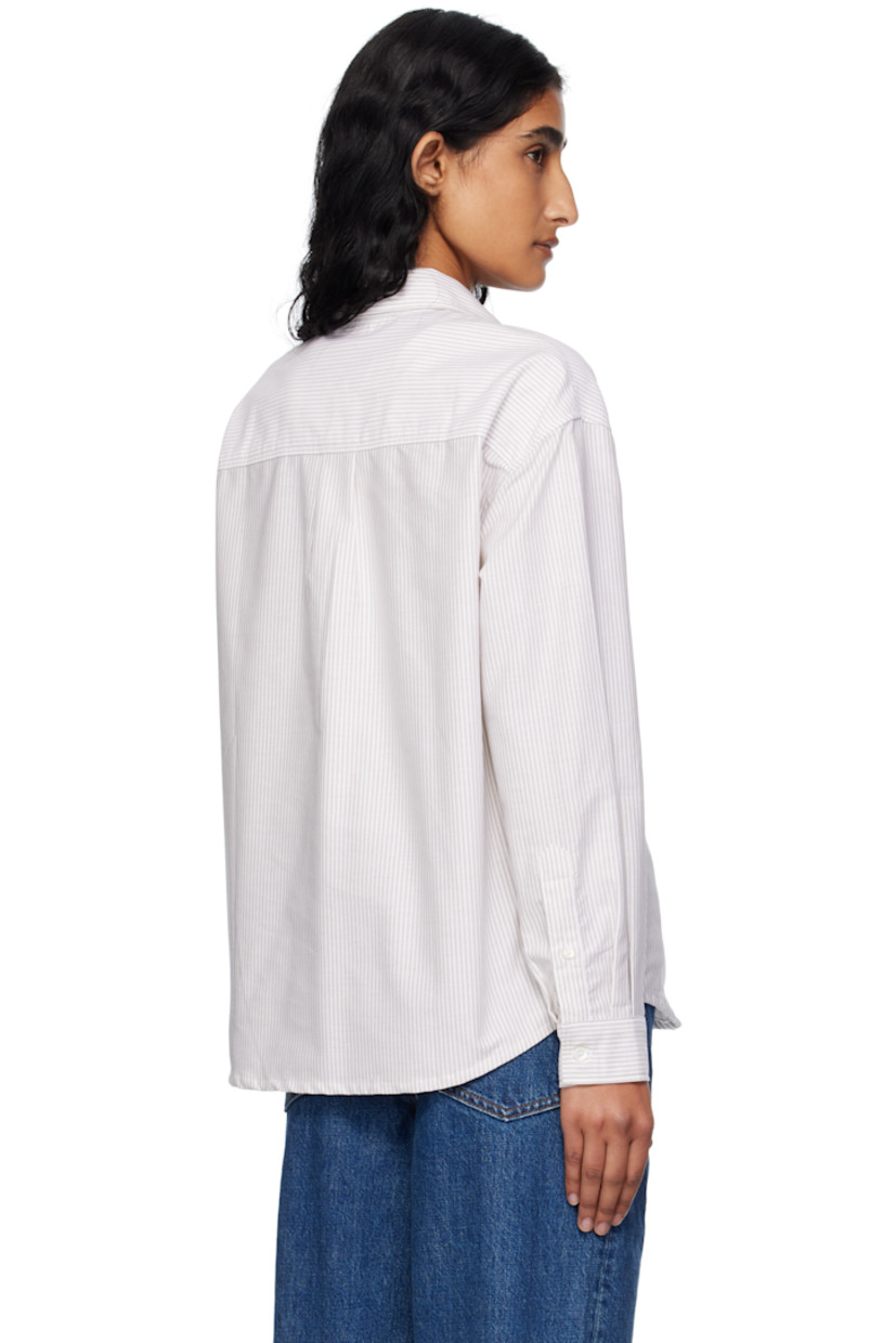 Organic cotton oxford cloth shirt.

· Stripes throughout
· Spread collar
· Button closure
· Logo-embroidered patch pocket at chest
· Shirttail hem
· Buttoned barrel cuffs
· Box pleat at back yoke
· Mother-of-pearl hardware

Supplier color: Beige