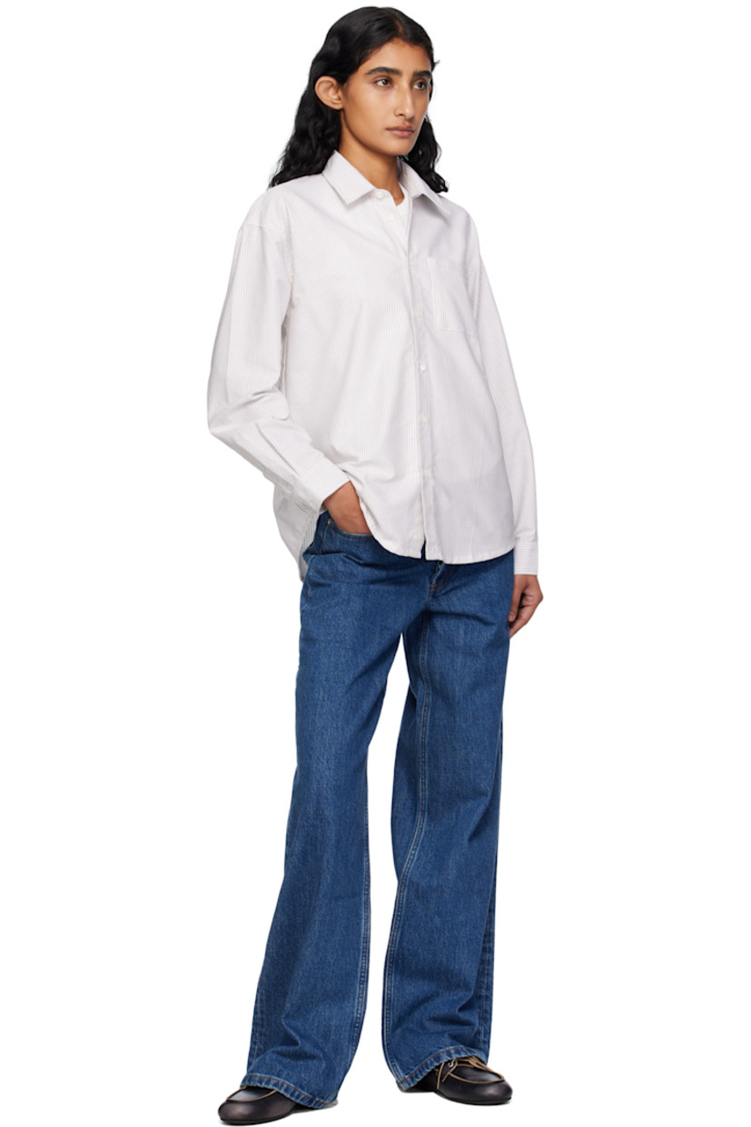 Organic cotton oxford cloth shirt.

· Stripes throughout
· Spread collar
· Button closure
· Logo-embroidered patch pocket at chest
· Shirttail hem
· Buttoned barrel cuffs
· Box pleat at back yoke
· Mother-of-pearl hardware

Supplier color: Beige