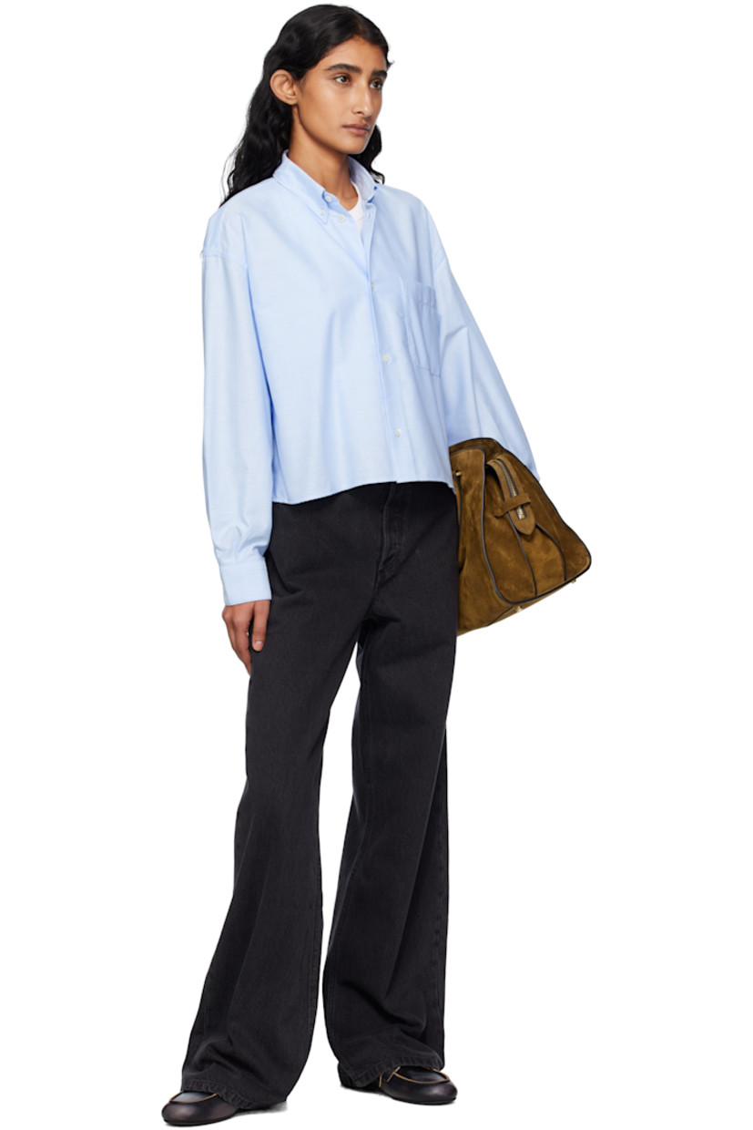 Organic cotton oxford cloth shirt.

· Spread collar
· Button closure
· Logo-embroidered patch pocket at chest
· Dropped shoulders
· Buttoned barrel cuffs
· Box pleat at back yoke

Supplier color: Light blue