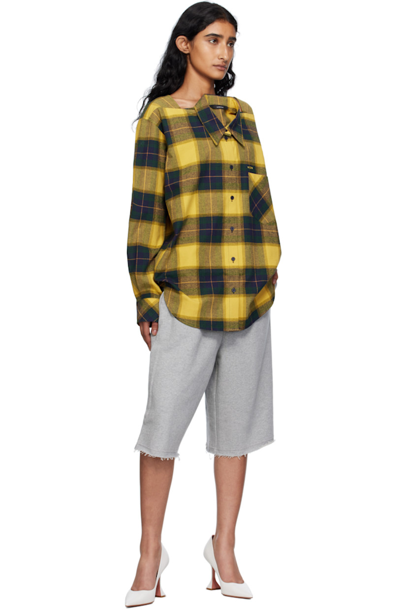 Cotton flannel shirt.

· Check pattern throughout
· Square neck
· Spread collar for alternate styling
· Button closure
· Embroidered text and patch pocket at chest
· Shirttail hem
· Dropped shoulders
· Buttoned barrel cuffs

Supplier color: Gn/Ch