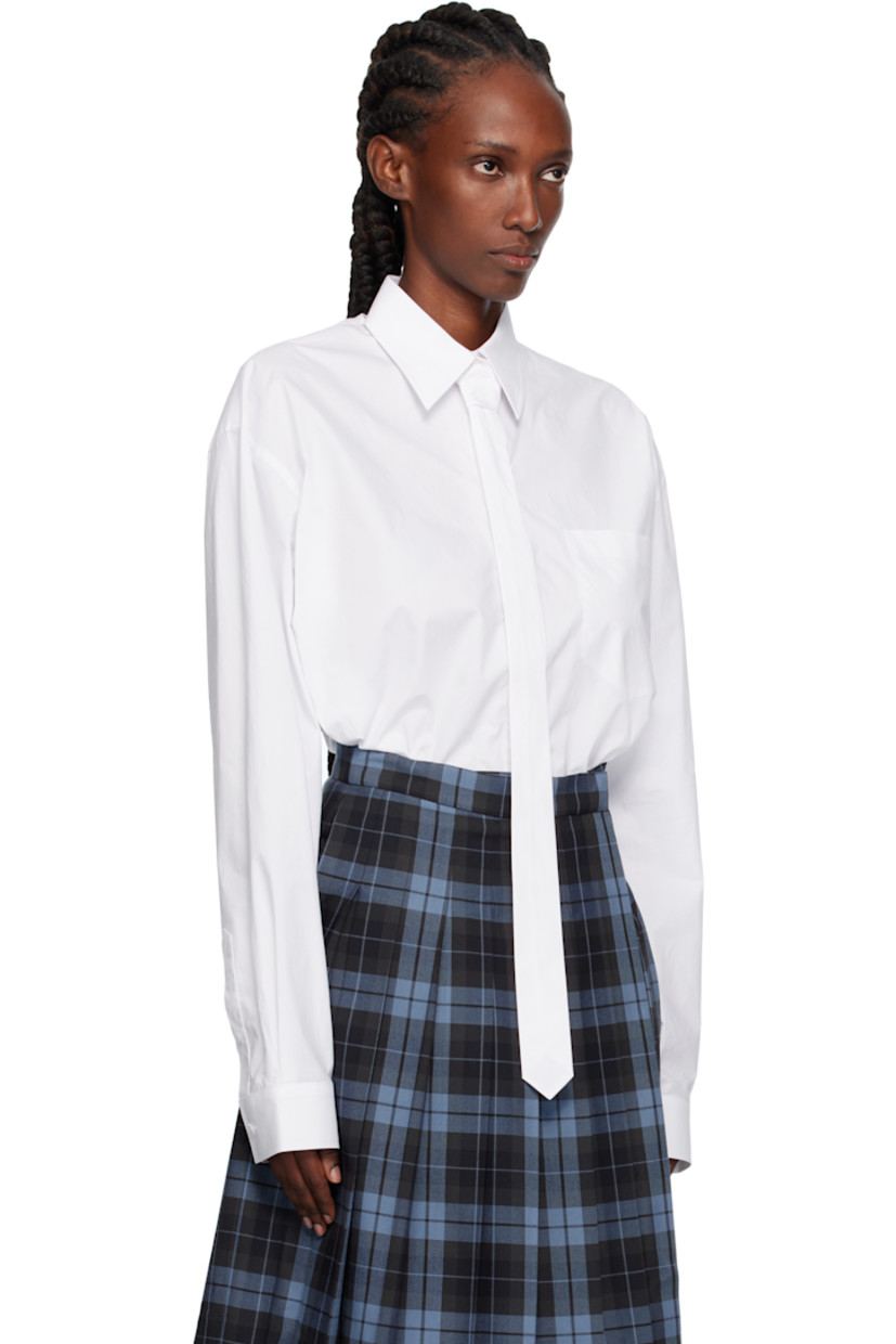 Cotton poplin shirt. 

· Extended tie-style straps and cutout at spread collar 
· Button closure
· Patch pocket at chest
· Shirttail hem 
· Dropped shoulders
· Buttoned barrel cuffs
· Box pleat at back yoke 

Supplier color: White