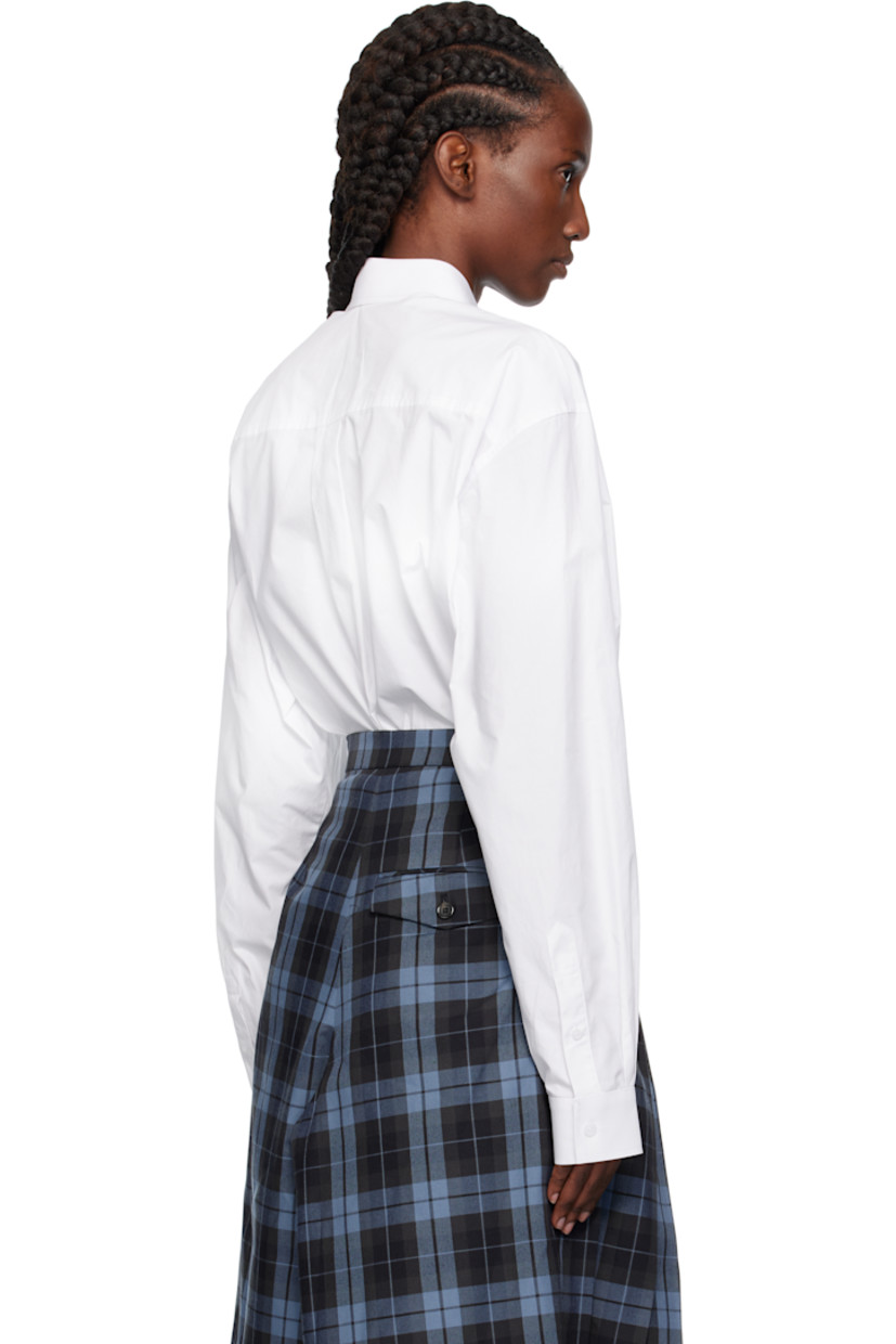 Cotton poplin shirt. 

· Extended tie-style straps and cutout at spread collar 
· Button closure
· Patch pocket at chest
· Shirttail hem 
· Dropped shoulders
· Buttoned barrel cuffs
· Box pleat at back yoke 

Supplier color: White