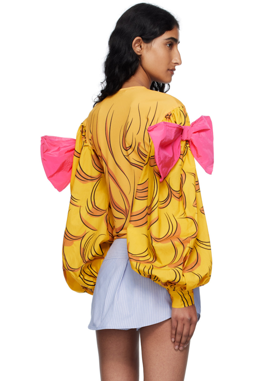 Jersey T-shirt.

· Graphic printed throughout
· Crewneck
· Bow accent at shoulders
· Gathering at poplin balloon sleeves
· Adjustable buttoned barrel cuffs

Supplier color: Yellow