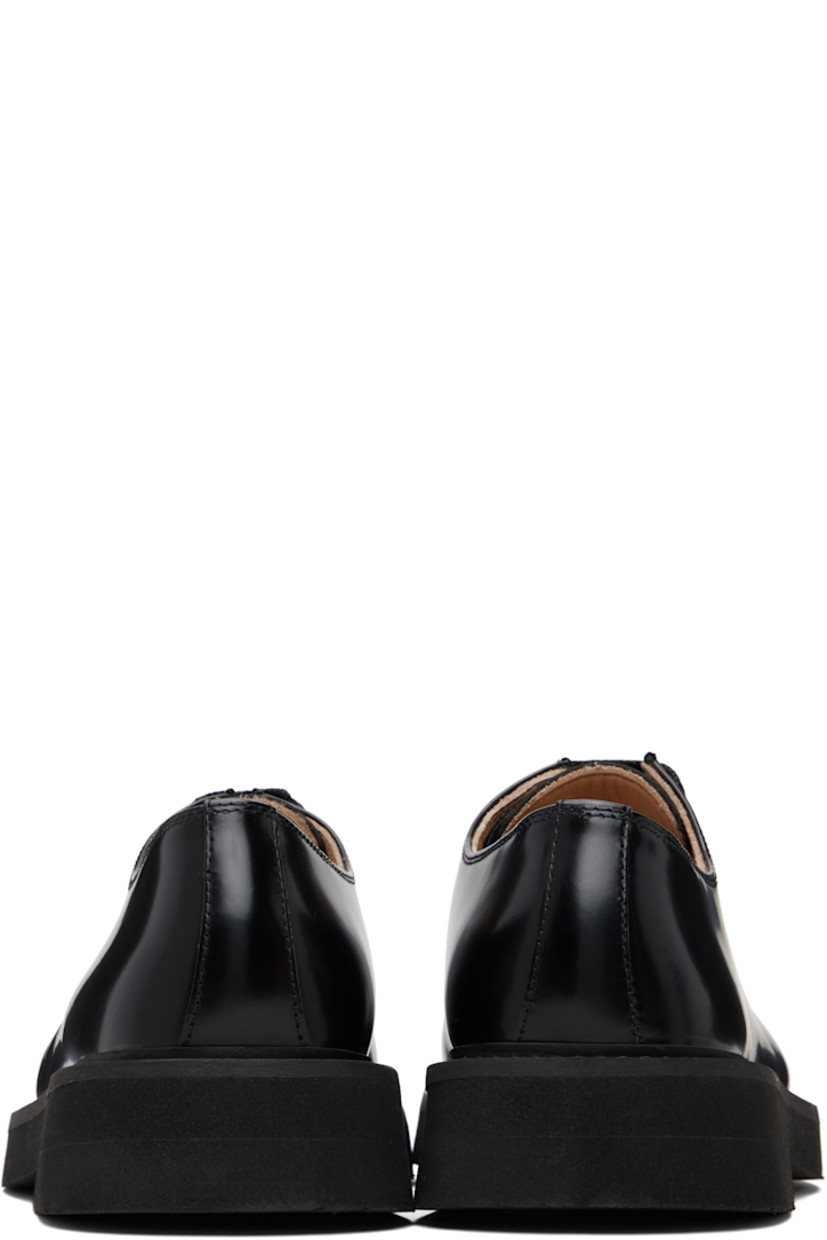 Polished leather oxfords.

· Moc toe
· Lace-up closure
· Topstitching at welt
· Foam rubber midsole
· Treaded rubber sole

Supplier color: Black