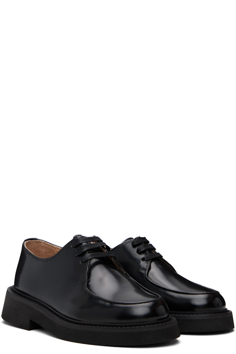 Polished leather oxfords.

· Moc toe
· Lace-up closure
· Topstitching at welt
· Foam rubber midsole
· Treaded rubber sole

Supplier color: Black