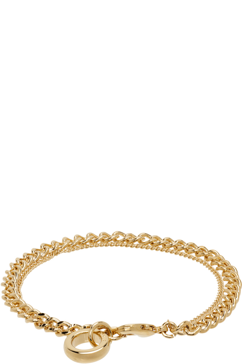 Tiered curb chain bracelet in gold-tone brass. Logo charm at lobster-clasp fastening.

Supplier color: Or