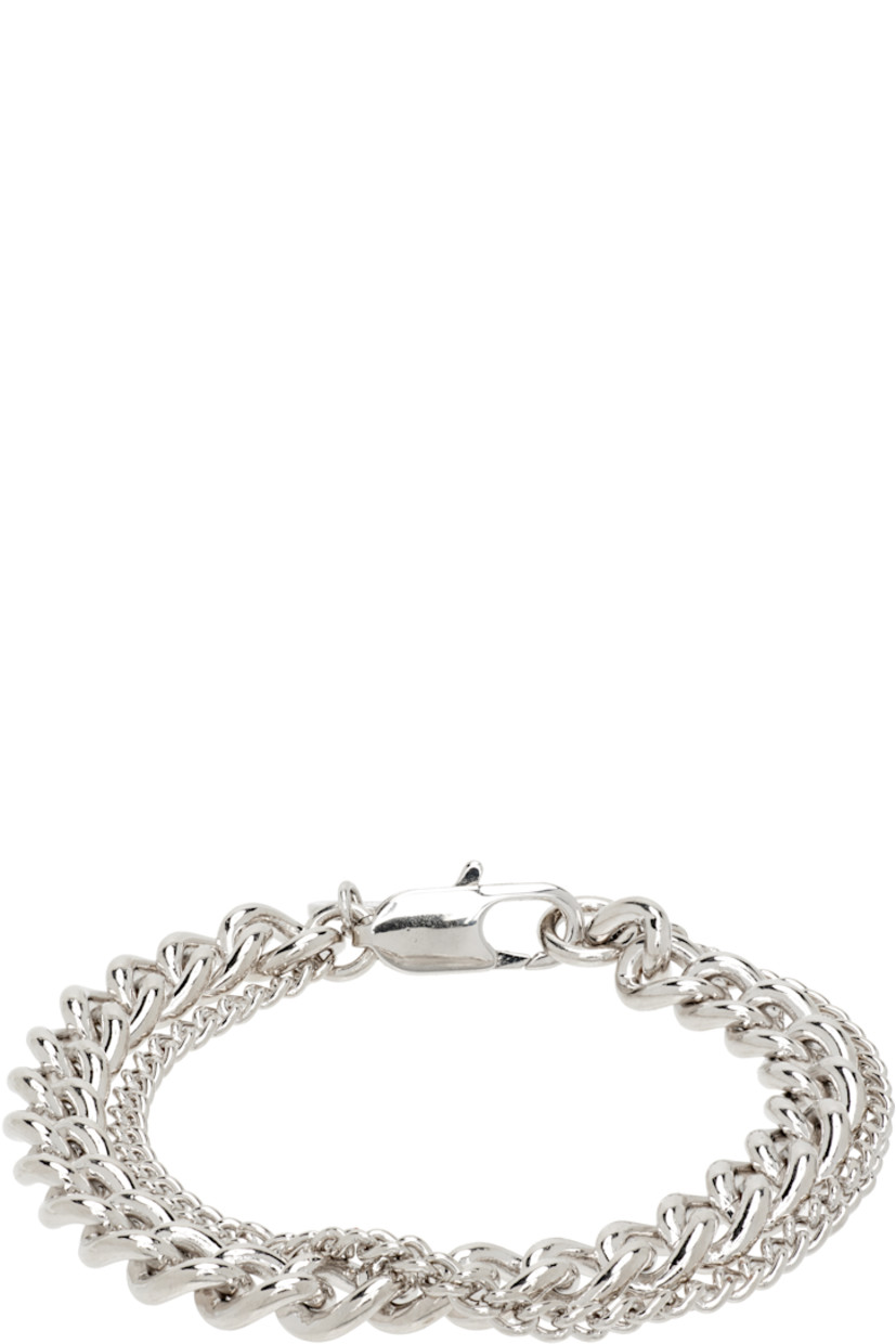 Tiered curb chain bracelet in silver-tone brass. Logo disc at lobster-clasp fastening.

Supplier color: Silver