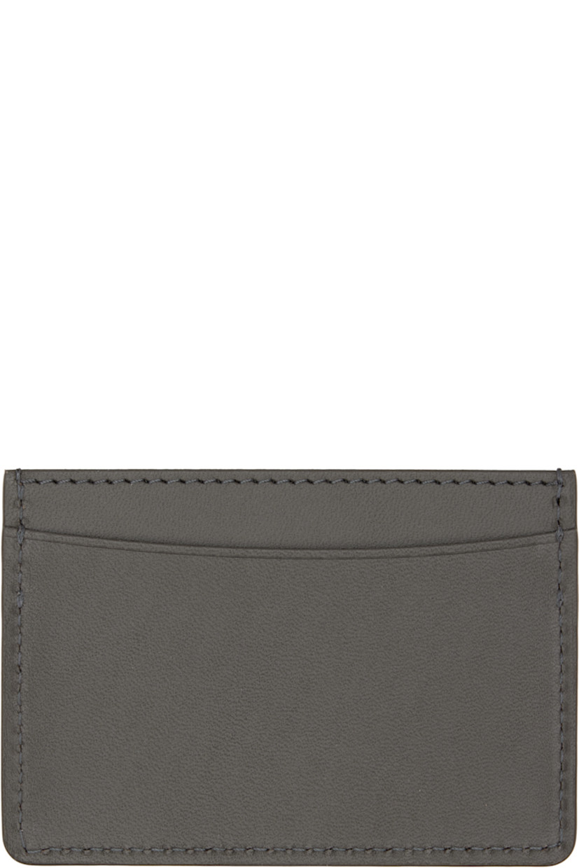 Buffed leather card holder. 

· Silver-tone logo stamp at face
· Three card slots
· Central note slot
· H3" x W4"

Supplier color: Coal