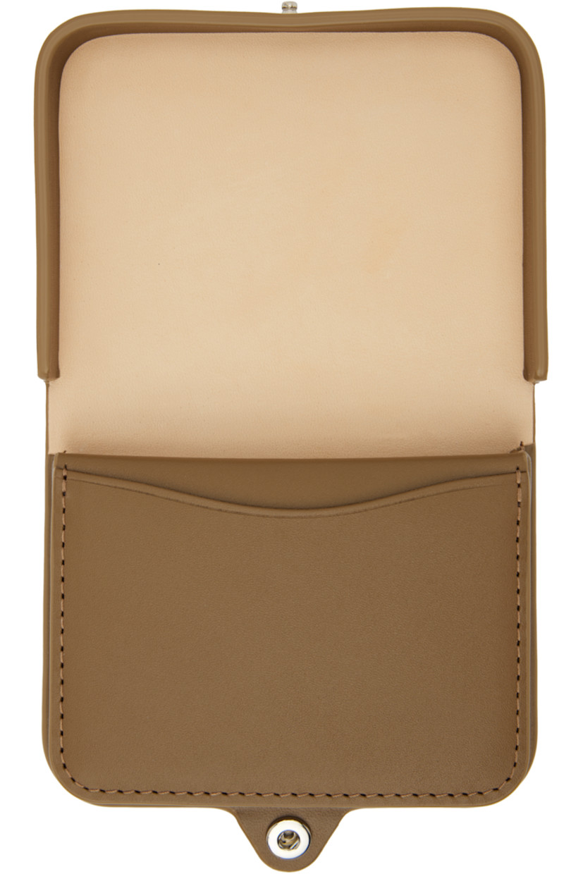 Vegetable-tanned buffed leather wallet.

· Logo stamp at face
· Press-stud closure
· Five card slots
· Coin compartment
· Plain-woven lining
· H3" x W4" x D0.75"

Supplier color: Soil