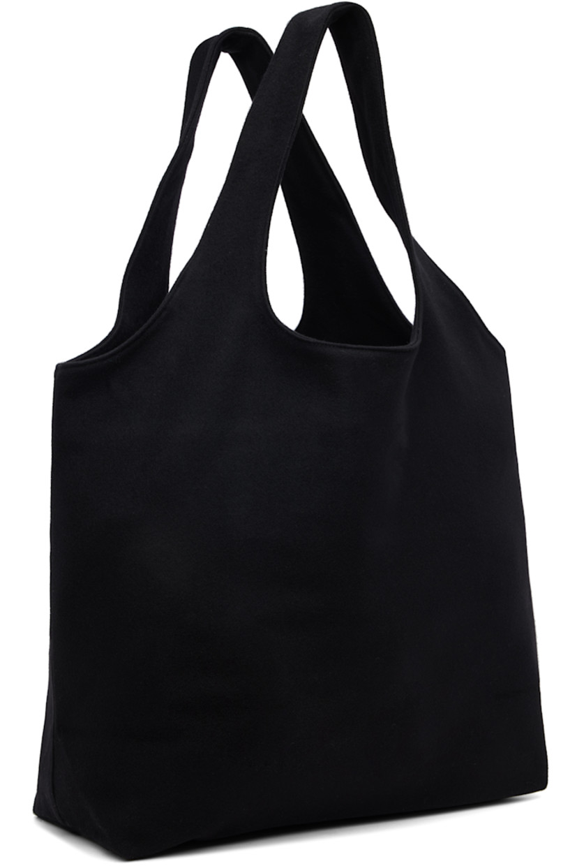 Felted tote.

· Integrated twin shoulder straps
· Logo printed at face
· Open throat
· Patch pocket at interior 
· Twill lining
· H13.5" x W19" x D6"

Supplier color: Black
