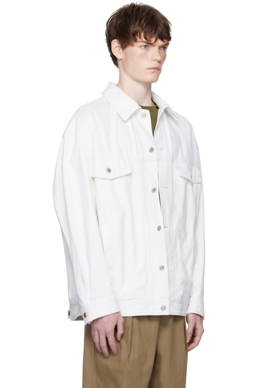 Non-stretch organic cotton denim jacket.

· Spread collar
· Button closure
· Flap and welt pockets at front
· Buttoned cuffs
· Adjustable button tabs at back hem

Supplier color: Off white