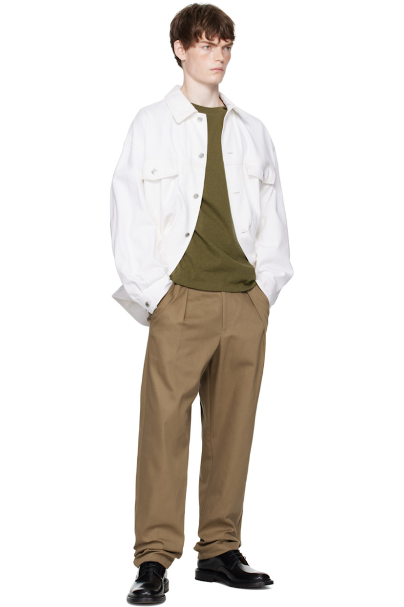 Non-stretch organic cotton denim jacket.

· Spread collar
· Button closure
· Flap and welt pockets at front
· Buttoned cuffs
· Adjustable button tabs at back hem

Supplier color: Off white