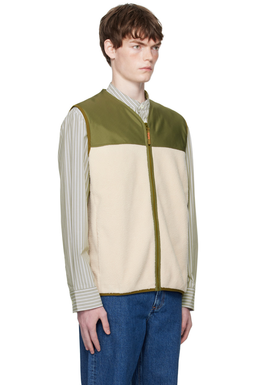 Taffeta and fleece vest.

· Paneled construction
· V-neck
· Zip closure
· Seam pockets
· Elasticized hem and armscyes
· Partial mesh lining

Supplier color: Off white