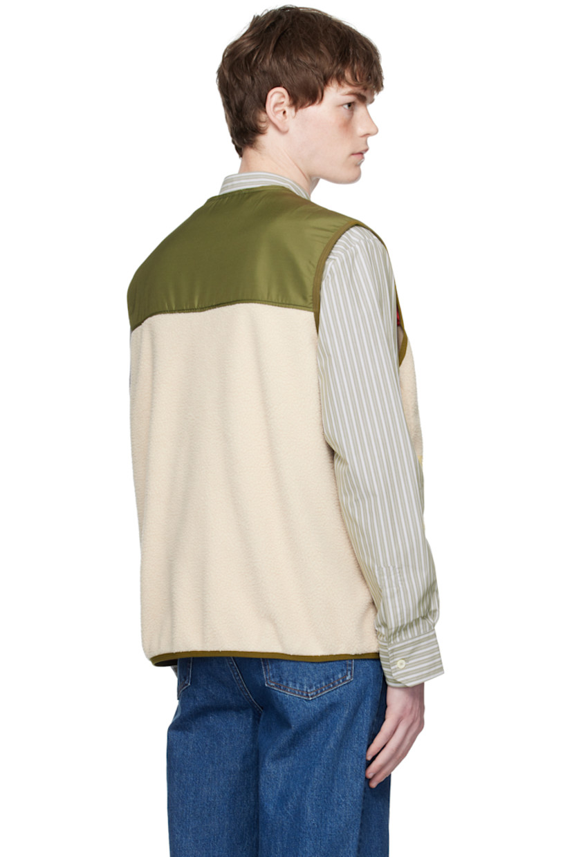 Taffeta and fleece vest.

· Paneled construction
· V-neck
· Zip closure
· Seam pockets
· Elasticized hem and armscyes
· Partial mesh lining

Supplier color: Off white
