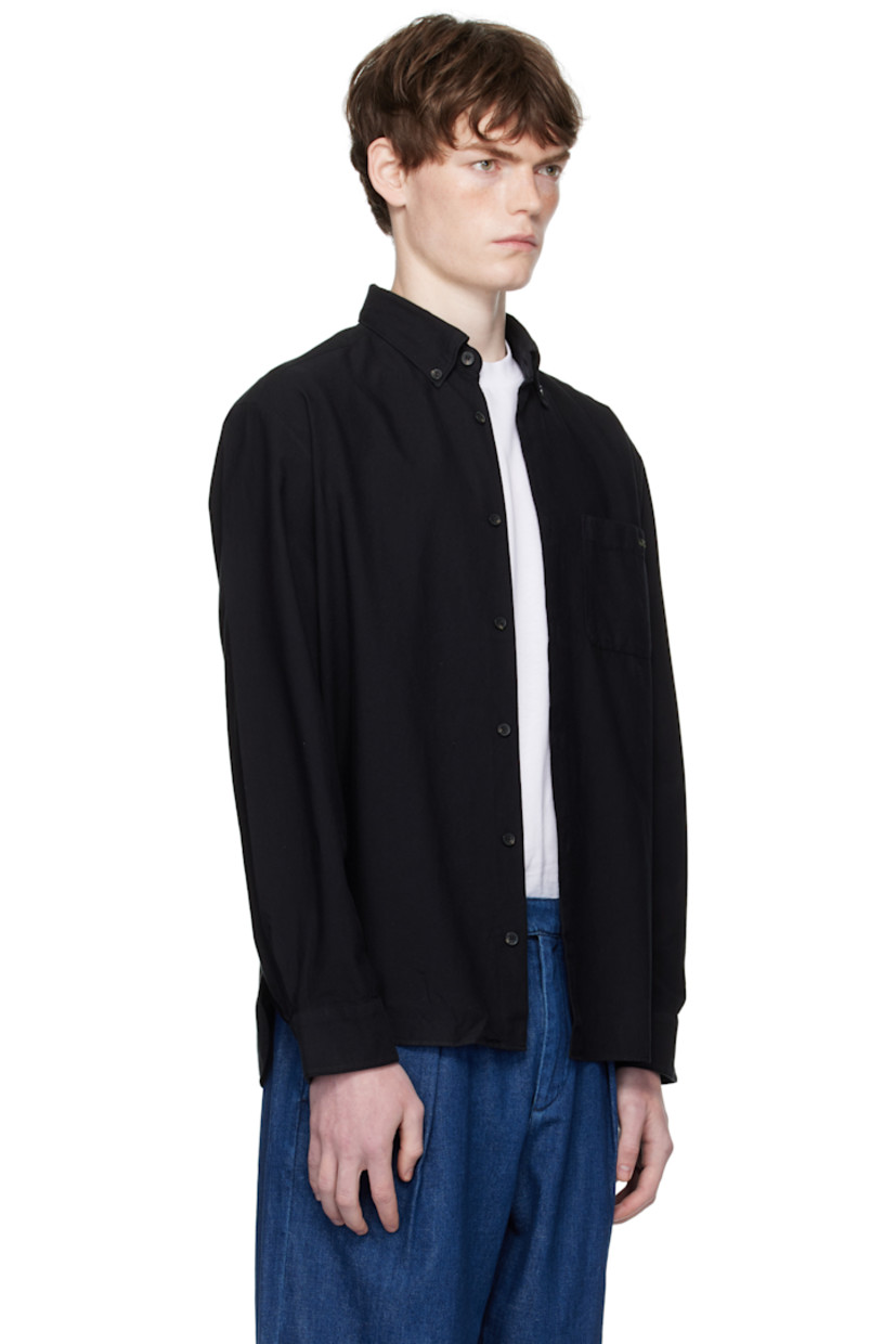 Organic cotton oxford cloth shirt.

· Button-down spread collar
· Button closure
· Logo-embroidered patch pocket at chest
· Shirttail hem
· Buttoned barrel cuffs
· Pleats at back yoke
· Faux-horn hardware

Supplier color: Noir