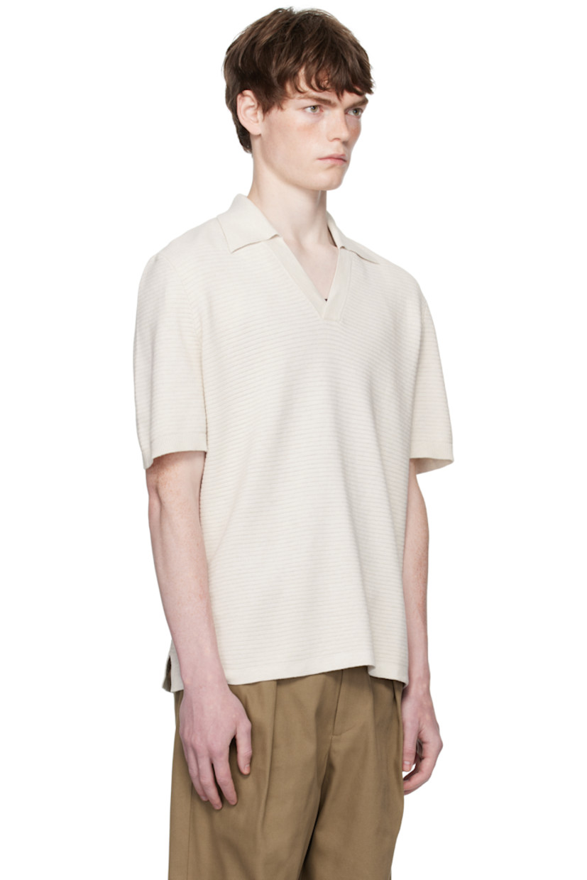 Textured knit cotton polo.

· Rib-knit spread collar and cuffs
· Open placket
· Vented side seams

Supplier color: Heathered ecru